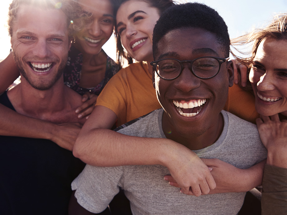 Five friends smiling together