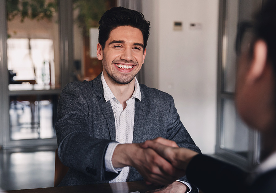 Man shaking someone's hand and smiling